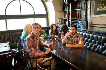 Image showing friends with beer watching football at bar or pub