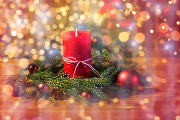 Image showing christmas fir wreath with candle on wooden table