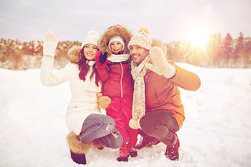 Image showing happy family waving hands outdoors in winter