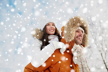 Image showing happy couple having fun over winter background