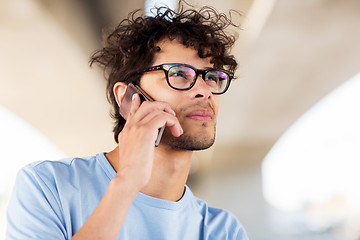 Image showing man with smartphone calling on city street