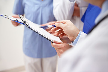 Image showing close up of doctors with clipboard at hospital