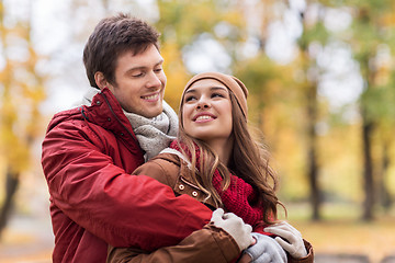 Image showing happy young couple hugging in autumn park