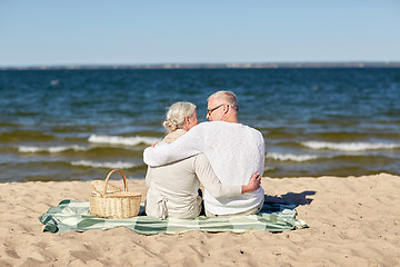 Image showing happy senior couple hugging on summer beach