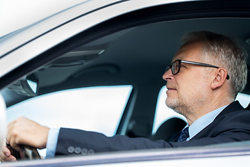 Image showing happy senior businessman driving car