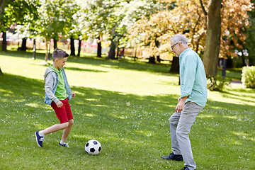 Image showing old man and boy playing football at summer park