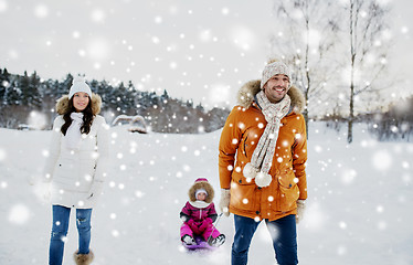 Image showing happy family with sled walking in winter outdoors