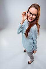 Image showing The smiling young business woman on gray background