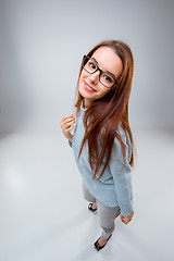 Image showing The smiling young business woman on gray background