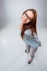 Image showing The smiling young business woman on gray background