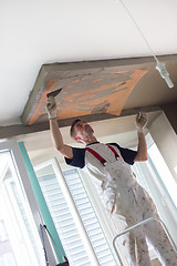 Image showing Plasterer renovating indoor walls and ceilings. Finishing works.