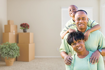 Image showing African American Family In Room with Packed Moving Boxes