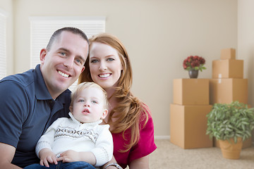 Image showing Young Military Family in Empty Room with Packed Boxes