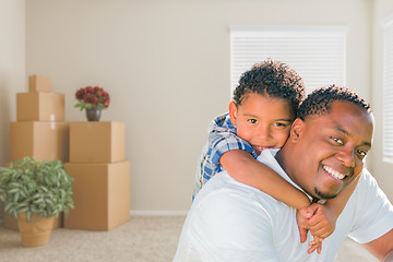 Image showing Mixed Race African American Father and Son In Room with Packed M