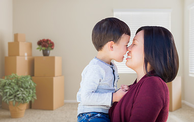 Image showing Mixed Race Chinese Mother and Child in Empty Room with Packed Mo