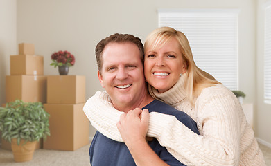 Image showing Young Couple in Empty Room with Packed Boxes