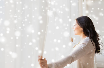 Image showing close up of woman opening window curtains