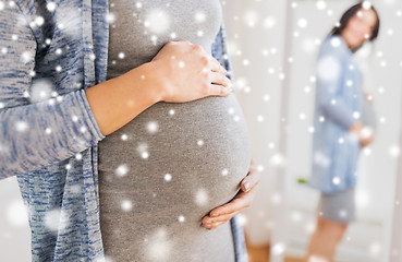 Image showing close up of pregnant woman looking to mirror