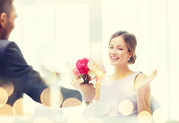 Image showing amazed woman recieving bouquet of flowers