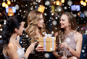 Image showing happy women with champagne and gift at night club