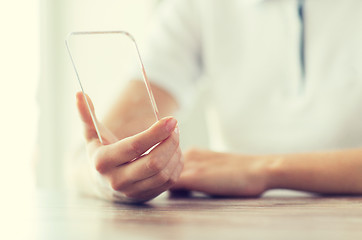 Image showing close up of woman with transparent smartphone