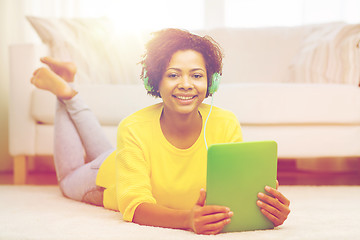 Image showing happy african woman with tablet pc and headphones