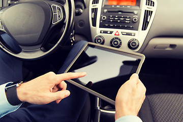 Image showing close up of young man with tablet pc driving car