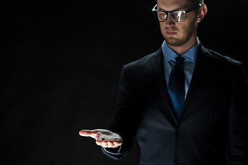 Image showing close up of businessman holding something on hand