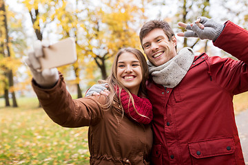 Image showing couple taking selfie by smartphone in autumn park