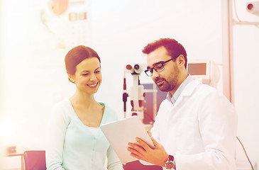 Image showing optician with tablet pc and patient at eye clinic