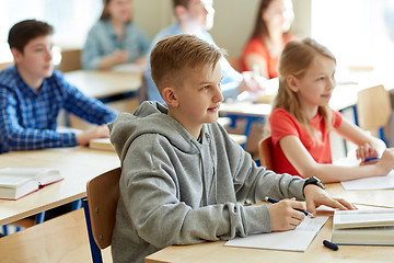 Image showing group of students with notebooks at school lesson