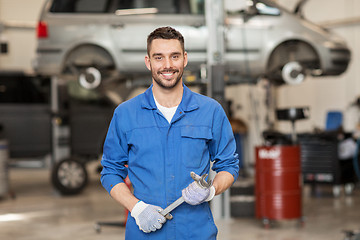 Image showing auto mechanic or smith with wrench at car workshop