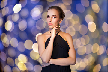 Image showing beautiful woman in black wearing diamond jewelry