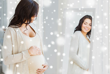 Image showing close up of pregnant woman looking to mirror