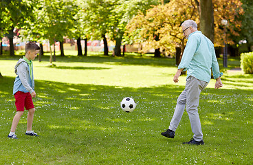 Image showing old man and boy playing football at summer park