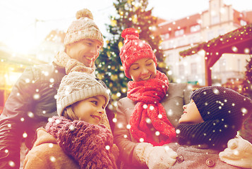 Image showing happy family over city christmas tree and snow