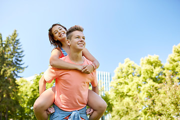 Image showing happy teenage couple having fun at summer park