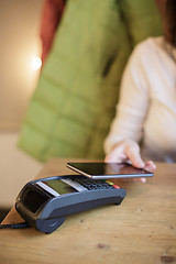 Image showing Woman pays the bill in the cafe with their smartphone