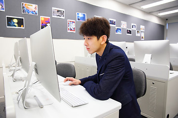 Image showing young man using computer in classroom