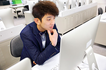 Image showing young man using computer in classroom