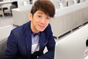 Image showing young man using computer in classroom