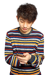 Image showing Young man using mobile phone texting