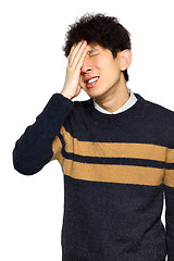 Image showing Closeup portrait, stressed young asian man, hands on head with b