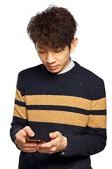 Image showing young asia man texting on mobilephone