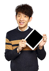 Image showing Handsome young Asian man using tablet / pad