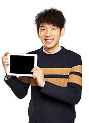 Image showing Handsome young Asian man using tablet / pad