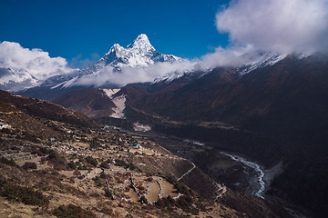 Image showing Ama Dablam summit or peak and Nepalese village in Himalayas