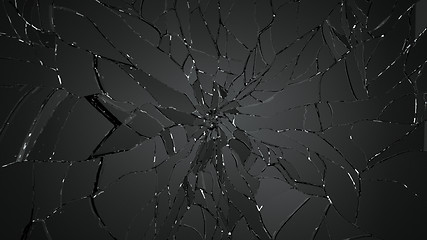 Image showing Pieces of splitted or cracked glass on black