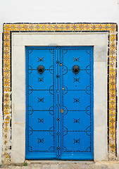 Image showing Blue aged door with ornament and tiles from Sidi Bou Said 