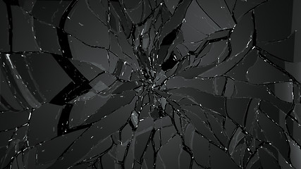 Image showing Pieces of splitted or cracked glass on black